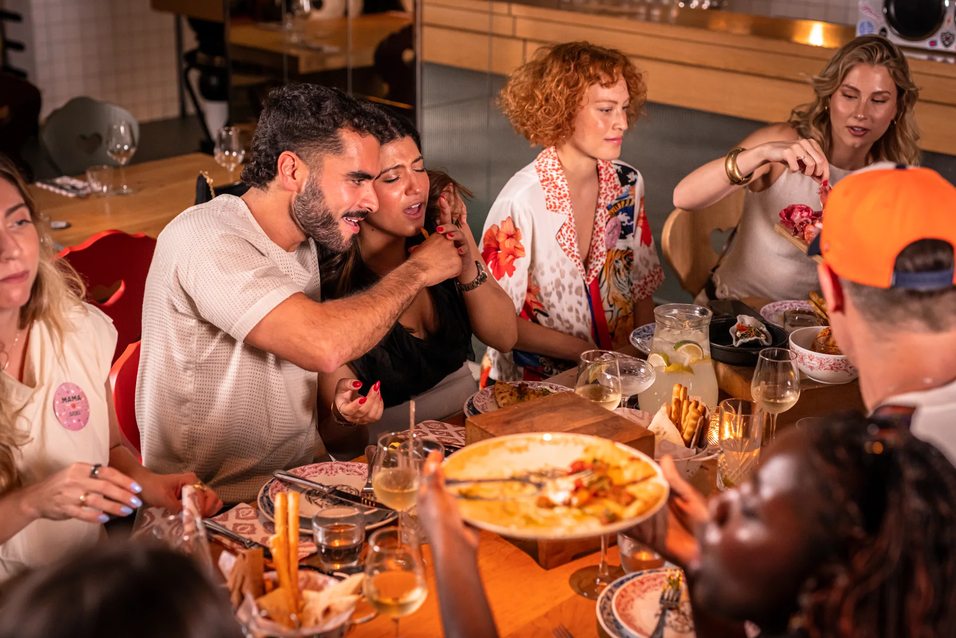 Friends sharing dinner at Mama Shelter Lisboa restaurant